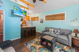 a living room with a couch and a kitchen at Sunset Suite Colony in Key West