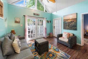 a living room with a couch and two chairs at Sunset Suite Colony in Key West