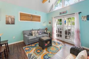a living room with a couch and a table at Sunset Suite Colony in Key West +14 photos