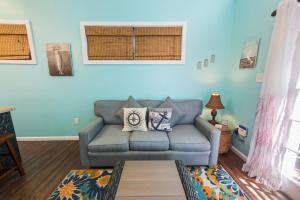 a living room with a couch and a window at Sunset Suite Colony in Key West