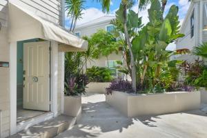 a front door of a house with trees and plants at Casabella Duval Square in Key West