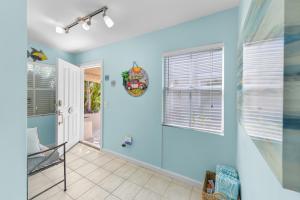 a bathroom with blue walls and a glass shower stall at Casabella Duval Square in Key West