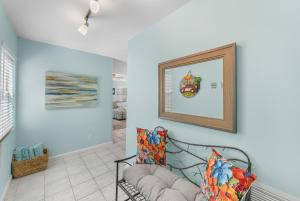 a living room with a bench and a mirror at Casabella Duval Square in Key West