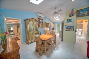 a kitchen and dining room with a wooden table and chairs at South St Cottage in Key West