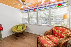 a living room with a couch and chairs and a window at Escape On Fleming in Key West