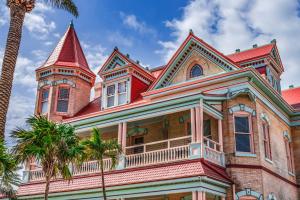 an ornate house with a turret and a palm tree at La Casa De Luna in Key West