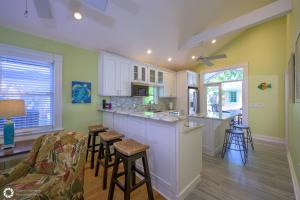 a kitchen with a bar and stools in a room at Royal Escape in Key West