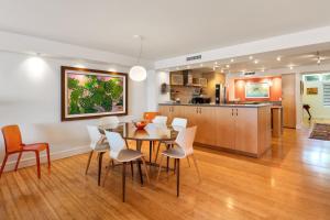 a dining room and kitchen with a table and chairs at Beach Club Shangra La 206 in Key West