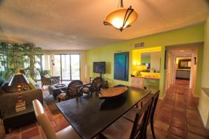 a living room with a table and a dining room at Vista Fresco in Key West