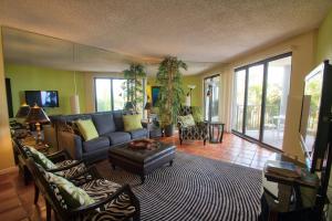 a living room with a couch and a table at Vista Fresco in Key West