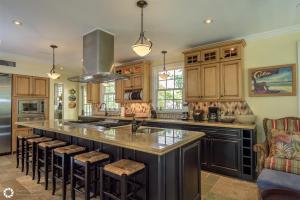 a kitchen with a large island with a counter top at Ole Olivia in Key West
