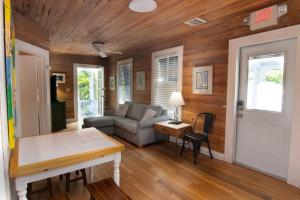 a living room with a couch and a table at Utopia Tropical Village in Key West