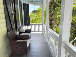 a porch with chairs and a view of the ocean at Utopia Tropical Village in Key West
