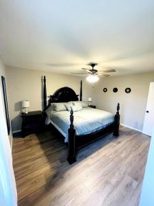 a bedroom with a bed and a ceiling fan at Full HOME with 2 KING BEDS and a POOL in Owasso