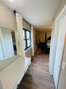a hallway of a room with a bed and a window at Full HOME with 2 KING BEDS and a POOL in Owasso +19 photos
