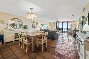 a dining room and living room with a table and chairs at Beach Club Oasis 304 in Key West