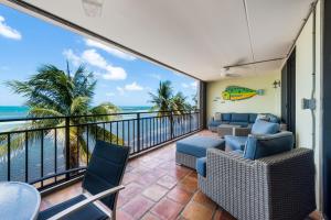 a balcony with chairs and a view of the ocean at Beach Club Oasis 304 in Key West