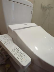 a white toilet with a remote control next to it at 海雲間 in Taitung City