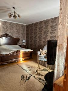 a bedroom with a bed and a tv in it at Qusar şahdağ turizm yaxınlıği gunluk kirye evlər in Qusar