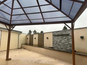 a view of a building with a glass roof at Agréable maison neuve de plain pied in Villiers-le-Sec
