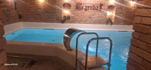 a hot tub in a brick building with a staircase in it at Hotel Legenda in Toruń