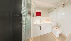 a bathroom with a sink and a toilet and a shower at Hostal Marino in San Antonio