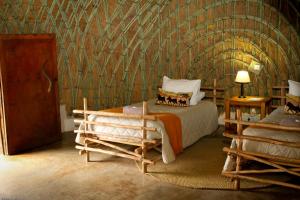 Posteľ alebo postele v izbe v ubytovaní Mlilwane Game Sanctuary