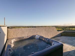 a hot tub sitting on top of a building at Apple Tree Barn in Dalton in Furness