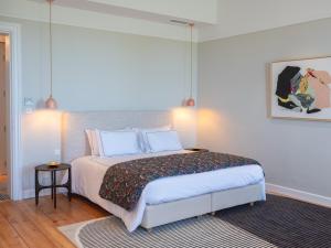 a bedroom with a bed with white sheets and pillows at Bed & Breakfast du château Grand Corbin in Saint-Émilion