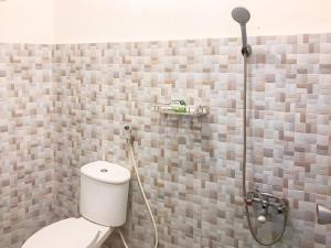 a bathroom with a shower with a toilet in it at Villa Bunga Guest House RedPartner in Malang +47 photos