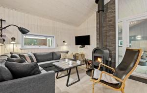 a living room with a couch and a fireplace at Holiday Home Engesøvej Vejers Strand Denm in Vejers Strand