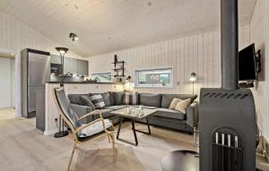 a living room with a couch and a fireplace at Holiday Home Engesøvej Vejers Strand Denm in Vejers Strand
