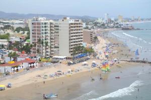 a view of a beach with people and buildings at Las Flores Beach Resort in Mazatl&aacute;n