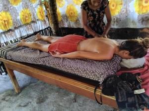a shirtless man laying on a bed with a woman at Mahee house in Hiriketiya