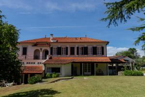 a large house with a red tile roof at Casa de Vila Flor in Grijó