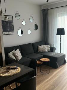 a living room with a couch and a table at Apartament Berlin in Pniewy