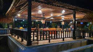 a restaurant with awning and a bar with tables at Coconut Village Guesthouse and Bungalow in Kep