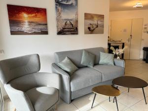 a living room with a couch and a table at Panoramic view, perfect between sea and mountain in Mandelieu-La Napoule