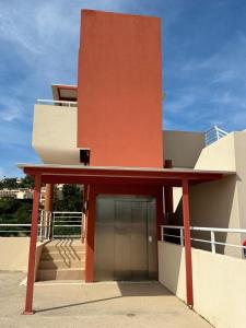 a red building with a door in front of it at Panoramic view, perfect between sea and mountain in Mandelieu-La Napoule