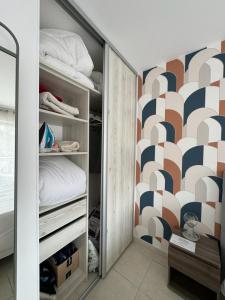 a bedroom with a closet with a bed and a geometric wall at Panoramic view, perfect between sea and mountain in Mandelieu-La Napoule +35 photos