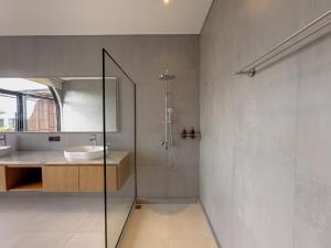a bathroom with a sink and a glass shower at 4Bedroom Umah Jeng Alessia Villa - Pererenan by SooBali in Munggu