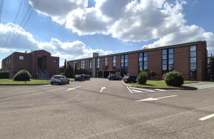 a parking lot in front of a brick building at Hotel Le Cerbaie in Altopascio +26 photos