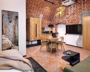 a living room with a brick wall at Nomadic Urban Premium Suites in Krakow