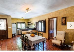 a kitchen and dining room with a table and chairs at Cortijo Rica in Seco de Lucena