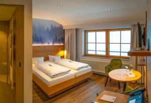 Postel nebo postele na pokoji v ubytování Berghotel Mummelsee