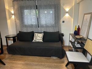 a bed sitting in a room with a window at Nest suite by Oikies Rentals in Neoi Epivates