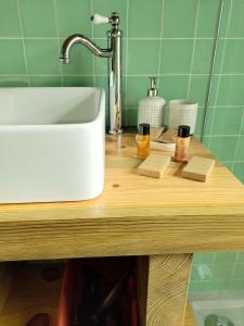 a kitchen counter with a white sink and some cups at 1 minute from beach - Baleal Wood Cabin in Baleal +38 photos