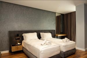 a hotel room with two beds with towels on them at Bounty Hotel in Golem +80 photos