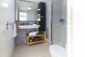 a bathroom with a sink and a shower at Nueva S 523 by VillaGranCanaria in San Agustin +23 photos