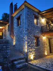 a stone house with lights on the side of it at Kleitor Stone Villa-Peloponnese Getaway in Klitoria
